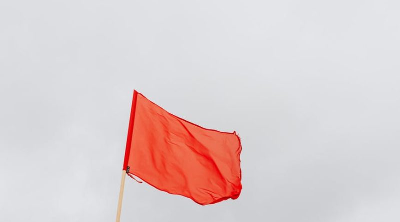 red flag on pole swaying by the wind